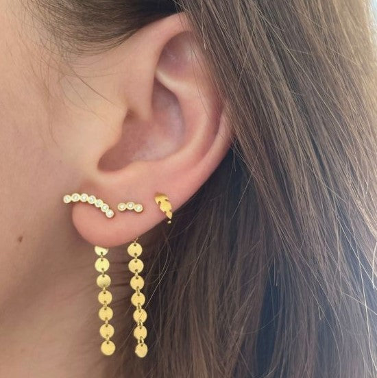 Petit coins behind earring